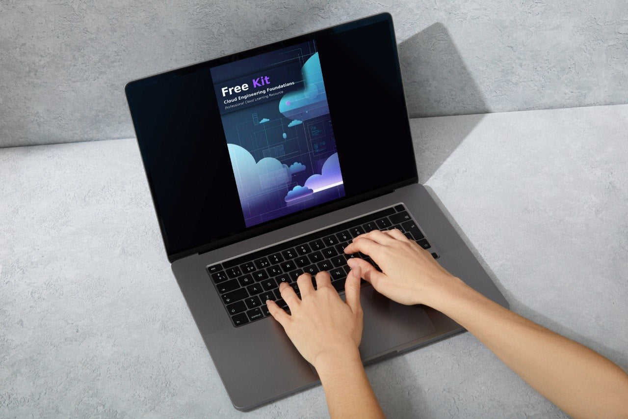 A person's hands typing on a dark gray laptop with an open screen displaying a 'Spark Course' graphic, set against a light gray textured background.